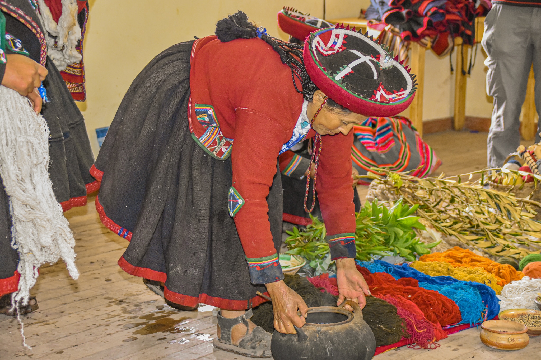 Being shown how to dye clothing when backpacking Peru