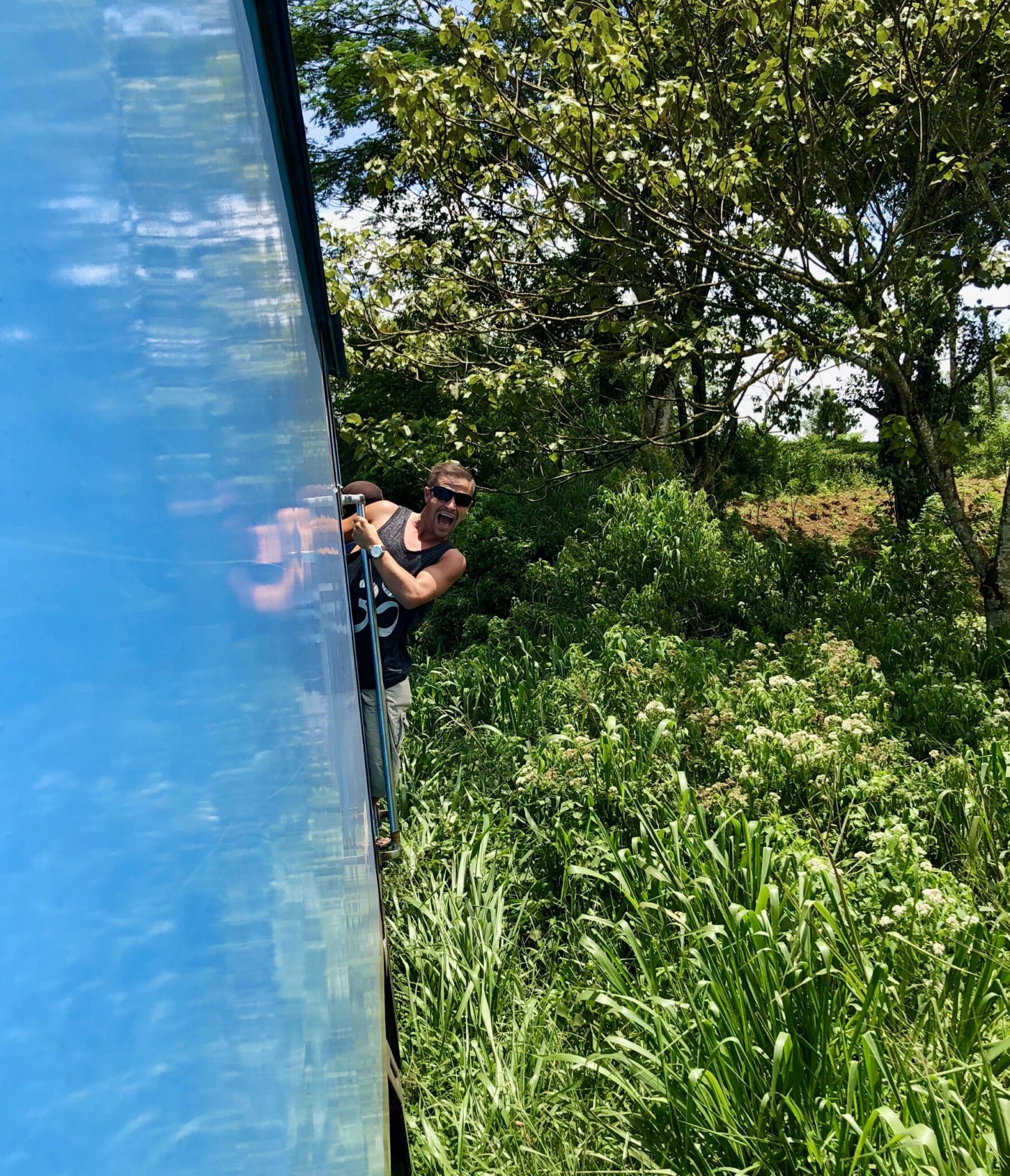Backpacking Sri Lanka as I hang out of the Kandy to Ella Train