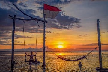 Paradise moments lookover the sun setting over Bali from the beach swing on the Gili's